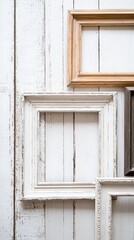 Fototapeta premium Overlapping Vintage Picture Frames on White Wooden Wall