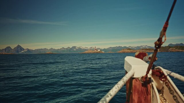 Bow pov: fishing boat navigating on the Norwegian sea offshore the Lofoten Islands, Norway.