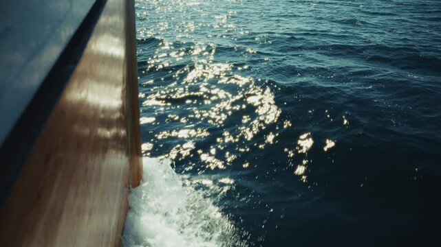 Pov: Fishing boat navigating in the sea. View of the waves as the boat cuts through the sea.
