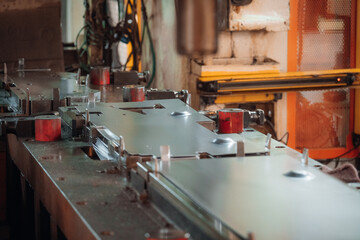 Industrial metal stamping press machine in operation shaping metal sheets with precision and...
