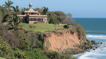 Scenic coastal view featuring a historic building on a cliff overlooking the ocean waves