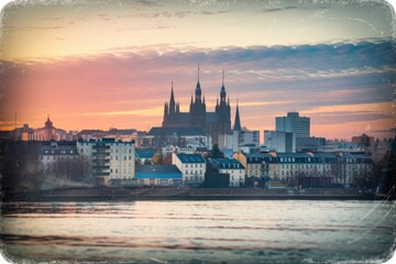 Obraz premium Moody Sunrise over European Cityscape with Cathedral, Buildings, and Waterfront in Retro Style with Washed-Out Tones