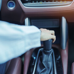 Business woman driver stick shift transmission a car gear, hand controlling steering wheel during...
