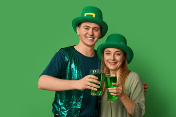 Happy friends with beer on green background. St. Patrick's Day celebration