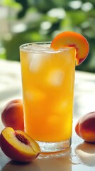Refreshing peach juice in a glass with ice on a sunny day