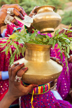 Asia, India, Gujarat,Dasada. Rabari, Mir tribes people. Putting money in a metal pot.