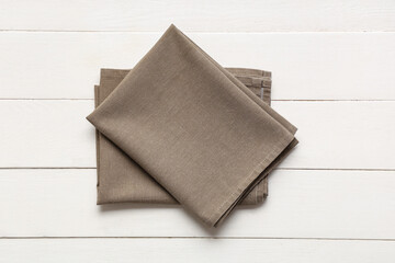Brown napkin on white wooden background