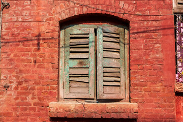 Asia, India, West Bengal, Kolkata near Sealdah Railway Station at Koley crossing. Shuttered window.