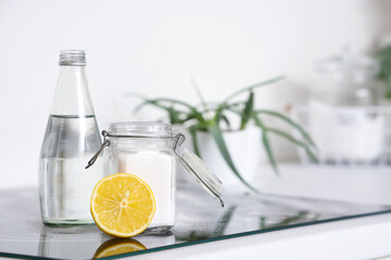 Lemon with baking soda and vinegar on stove in kitchen, closeup