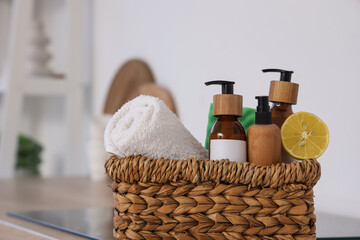 Basket with natural cleaning supplies and lemon on counter in kitchen, closeup