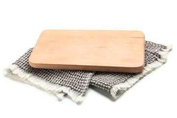 Wooden cutting board and napkin on white background