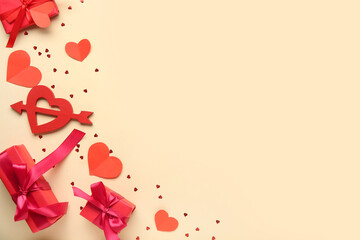 Gift boxes with hearts on light yellow background. Valentine's Day celebration