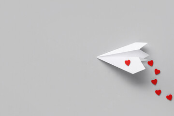Paper airplane with red hearts on white background. Valentine's Day celebration
