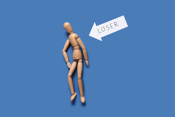 Arrow with word LOSER and wooden mannequin on blue background