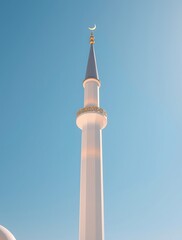 Obraz premium Minaret Tower Reaching Towards Clear Blue Sky with Golden Crescent