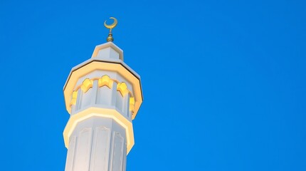Obraz premium Minaret of Mosque with Crescent Moon Against Clear Blue Sky