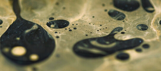 Serum blob. Blur fizzy liquid. Defocused yellow black color round oil bubbles mist texture fluid ink spill drip paint water flow on abstract art background.