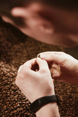 Barista holding freshly roasted coffee beans in hands