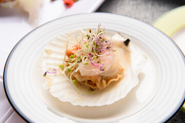 Steamed scallop shrimp and salad on a white plate
