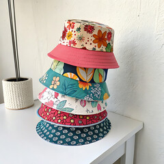  A stack of trendy bucket hats in various prints and patterns organized on a display