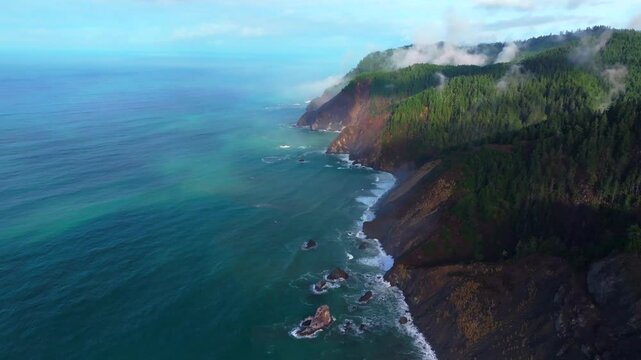 PNW Lost Coast Trail rugged dramatic untouched coastline aerial drone California surf waves boulder rocks USAL Beach campground cloudy mist fog sun rays morning nature landscape backwards motion