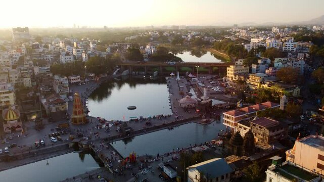 Panchavati Ganga Ghat, Hindu pilgrimage temples on holy Godavari river in evening, 2027 Kumbh Mela, Drone shot, Establishing shot