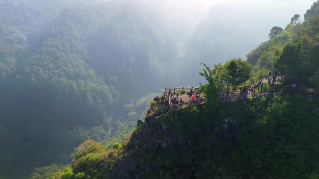 Tebing Keraton, a stunning cliffside viewpoint in Bandung, Indonesia. This high-resolution video captures the lush green forest, dramatic cliffs, and misty morning atmosphere