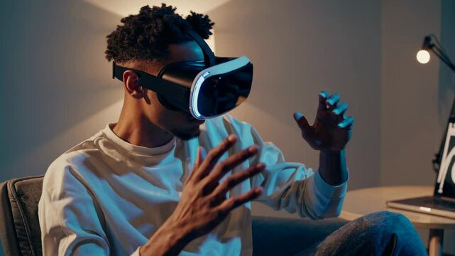 A man wearing VR goggles sits in a dimly lit room, viewed from a side angle, immersing in a virtual video experience, modern tech ambiance.