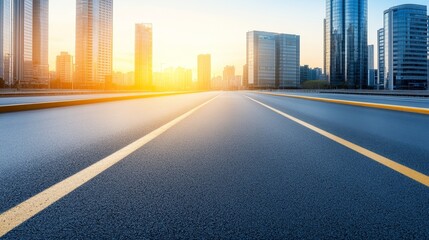 Fototapeta premium Sunset over a city skyline with empty road leading towards skyscrapers and vibrant sky