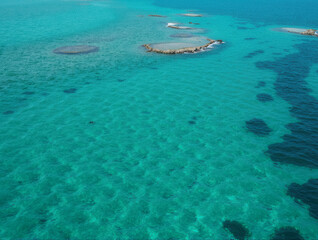 Fototapeta premium Aerial view of azure seascape with coral reefs and turquoise water in tranquil ocean