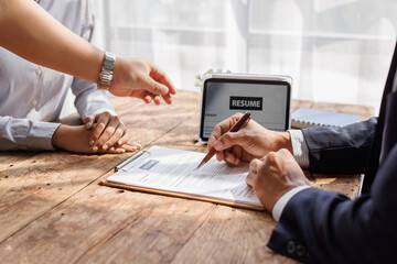Hands of recruiter holding resume in front of candidate at desk.employee job application concept.