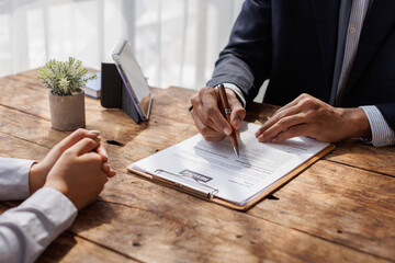 Hands of recruiter holding resume in front of candidate at desk.employee job application concept.