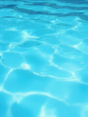 Fototapeta premium Clear blue water surface with sunlight reflections in a swimming pool