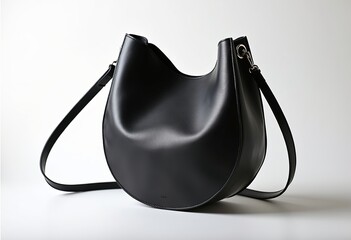 Minimalist Product Photography: Black Crescent Leather Bag with Shoulder Strap, Open Top on White Background, High Saturation, Shallow Depth of Field, and Soft Natural Lighting.

