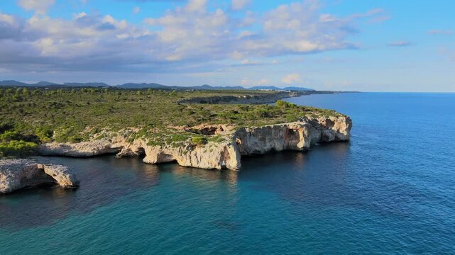 Discover the breathtaking cliffs and crystal-clear waters of Cala Varques in Porto Cristo, Majorca. Experience the beauty of nature and tranquility in this serene coastal location.