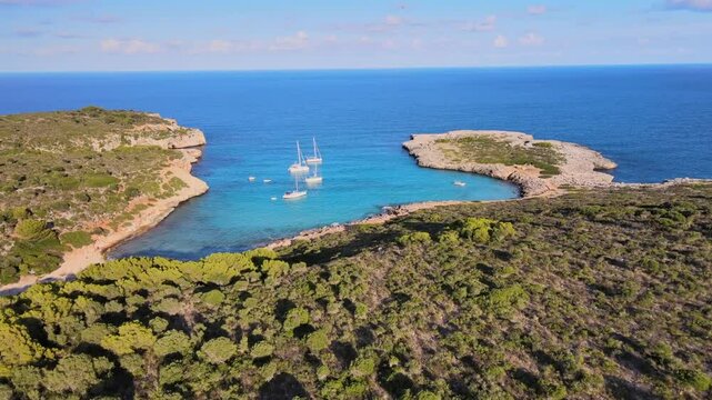 Explore the serene beauty of Cala Varques in Porto Cristo, Majorca. Enjoy breathtaking views of turquoise waters and lush greenery surrounding the peaceful bay.