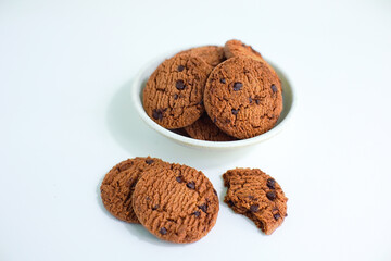 delicious chocolate biscuits in round shape in plate isolated on white background