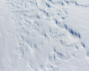 The snow is white and the ground is covered in it