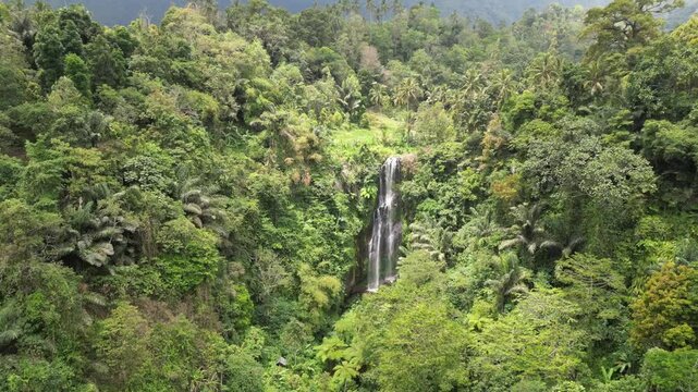 Gitgit Waterfall in Buleleng, Bali, is a stunning 35-meter cascade surrounded by lush rainforest. The serene atmosphere, cool mist, and soothing sound of rushing water make it a perfect nature retreat