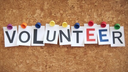 Word volunteer spelled out with papers pinned to corkboard