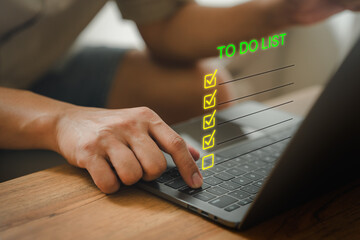 Person using a laptop computer with a virtual screen "To-Do List" overlay, featuring checked and unchecked tasks. Represents productivity, task management, digital checklist option, and planning work.