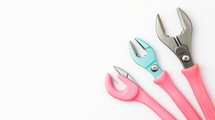 Soft pastel-colored hand tools like pliers framed for an organized, aesthetic workspace