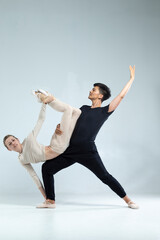 Asian Man and Caucasian Woman Performing As Ballet Dancers On Grey in Studio During Suppots As Classical Dance And Choreography © danmorgan12