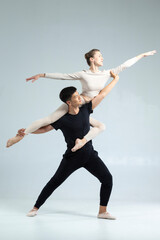Sporty Asian Man and Caucasian Woman Performing As Ballet Dancers On Grey in Studio During Suppots As Classical Dance And Choreography © danmorgan12
