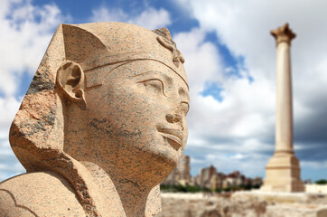 Famous landmark - Serapeum of Alexandria. Sphinx and Pompey's Pillar in Alexandria, Egypt, North...
