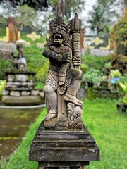 Traditional stone guardian statue from Bali, showcasing cultural heritage and artistic craftsmanship on Balinese Temple