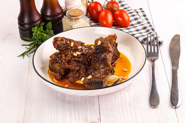 Prepared tasty beef ribs with sauce