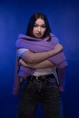 Young girl posing and moving on a blue background	