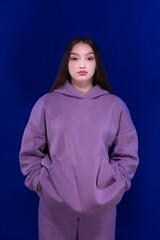 Young girl posing and moving on a blue background	