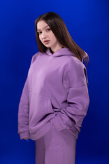 Young girl posing and moving on a blue background	